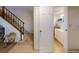 Hallway view of stairs and a half bathroom with tiled floors, vanity, and toilet at 144 S Halifax Ave # 86, Daytona Beach, FL 32118