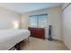 Bright bedroom featuring a wooden dresser, a window, and a closet at 144 S Halifax Ave # 86, Daytona Beach, FL 32118