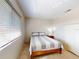 Well-lit bedroom featuring a comfy bed with a striped comforter, closet and window offering tranquil view at 144 S Halifax Ave # 86, Daytona Beach, FL 32118