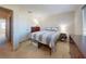 Cozy bedroom featuring carpet flooring, a bed with striped bedding, and a modern dresser at 144 S Halifax Ave # 86, Daytona Beach, FL 32118