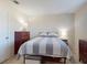 Comfortable bedroom featuring neutral tones, a bed with a striped quilt, and matching nightstands at 144 S Halifax Ave # 86, Daytona Beach, FL 32118