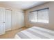 Bright bedroom with two closets, window with blinds, creating a serene and organized living space at 144 S Halifax Ave # 86, Daytona Beach, FL 32118