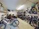 Bike storage features metal racks to maximize space in a well-lit room with shelving for extra storage at 144 S Halifax Ave # 86, Daytona Beach, FL 32118