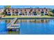 Waterfront condo building with a dock, pool, lounge chairs, and a lawn, overlooking the tranquil water at 144 S Halifax Ave # 86, Daytona Beach, FL 32118
