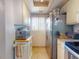 Compact kitchen features stainless steel refrigerator, microwave, and tile flooring at 144 S Halifax Ave # 86, Daytona Beach, FL 32118