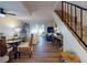 Bright living room with hardwood floors, staircase, glass table, and sliding door access to the patio at 144 S Halifax Ave # 86, Daytona Beach, FL 32118
