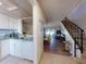 Spacious living area featuring wood floors, and access to a modern kitchen and the stairs at 144 S Halifax Ave # 86, Daytona Beach, FL 32118