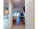 Open-concept living room visible from the kitchen with wood floors and natural light from the sliding glass doors at 144 S Halifax Ave # 86, Daytona Beach, FL 32118