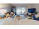 Inviting living room featuring a comfortable leather sofa, stylish shelving, and a sliding glass door to the outside at 144 S Halifax Ave # 86, Daytona Beach, FL 32118