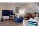 Cozy living room featuring a blue beanbag chair and a modern entertainment center with a large-screen TV at 144 S Halifax Ave # 86, Daytona Beach, FL 32118