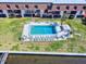 Beautiful aerial view showcasing a pristine pool with lounge chairs next to apartments and overlooking the intercoastal waterway at 144 S Halifax Ave # 86, Daytona Beach, FL 32118