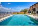 Community pool overlooks a tranquil river with an umbrella covered bridge and cityscape in the background at 144 S Halifax Ave # 86, Daytona Beach, FL 32118