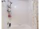 Shower-tub combination with tiled walls, a shower curtain, and convenient shelving at 144 S Halifax Ave # 86, Daytona Beach, FL 32118
