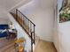 Carpeted staircase with black iron railing, leading to the upper level of the home at 144 S Halifax Ave # 86, Daytona Beach, FL 32118