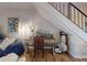 Study area features hardwood floors, a desk, a comfy chair and staircase at 144 S Halifax Ave # 86, Daytona Beach, FL 32118
