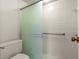 Bathroom featuring tiled shower, toilet, and grab bar at 160 Limewood Pl # 1, Ormond Beach, FL 32174