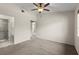 Bedroom featuring carpet, ceiling fan, and a doorway to the bathroom at 160 Limewood Pl # 1, Ormond Beach, FL 32174