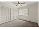 This bedroom features a ceiling fan, two large closets, carpeted floors, and a window providing natural light at 160 Limewood Pl # 1, Ormond Beach, FL 32174
