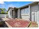 Neutral tone home with a yard, decorative mulch, and lush surrounding landscape at 160 Limewood Pl # 1, Ormond Beach, FL 32174