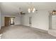 Spacious living room featuring a ceiling fan, pendant light, and neutral carpet at 160 Limewood Pl # 1, Ormond Beach, FL 32174