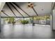 Large covered patio area with ceiling fans and view of surrounding trees and landscaping at 160 Limewood Pl # 1, Ormond Beach, FL 32174
