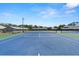 A community tennis court with residences in the background at 160 Limewood Pl # 1, Ormond Beach, FL 32174
