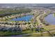 Community aerial view with pond; subject property indicated by a blue arrow at 1750 Savannah Ln, Port Orange, FL 32128