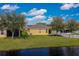 Scenic backyard view featuring a green lawn and a serene pond at 1750 Savannah Ln, Port Orange, FL 32128