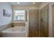 Bright bathroom featuring a soaking tub and separate glass-enclosed shower at 1750 Savannah Ln, Port Orange, FL 32128
