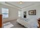 Comfortable bedroom featuring tray ceilings, lots of natural light, and a calming color palette at 1750 Savannah Ln, Port Orange, FL 32128