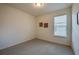 Well-lit bedroom with neutral carpet and a window providing natural light at 1750 Savannah Ln, Port Orange, FL 32128
