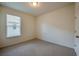 Bright bedroom with a window, neutral carpet, and a ceiling light at 1750 Savannah Ln, Port Orange, FL 32128