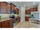 Modern kitchen with granite countertops, stainless steel appliances, and a light tile floor at 1750 Savannah Ln, Port Orange, FL 32128