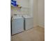 Functional laundry room with washer, dryer, and storage shelf at 1750 Savannah Ln, Port Orange, FL 32128
