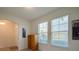 Bright room with tile floor, two large windows, and a view of the front yard at 1750 Savannah Ln, Port Orange, FL 32128