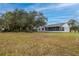 Expansive backyard with mature trees and lush green grass, perfect for outdoor entertaining at 1983 Stacey Cir, Deltona, FL 32738