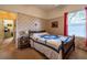Comfortable bedroom with carpet, complemented by floral wallpaper and large window enhancing the room's atmosphere at 1983 Stacey Cir, Deltona, FL 32738