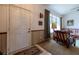 Welcoming entryway with front door, wood-look wainscoting, and a view into the inviting living room at 1983 Stacey Cir, Deltona, FL 32738