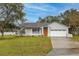 Charming home featuring a well-manicured lawn, attached garage, and freshly painted exterior at 1983 Stacey Cir, Deltona, FL 32738
