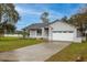 Charming single-story home with a well-manicured lawn, a two car garage, and a concrete driveway at 1983 Stacey Cir, Deltona, FL 32738