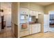 Traditional kitchen featuring white appliances and a view into the Primary bedroom at 1983 Stacey Cir, Deltona, FL 32738