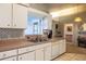 Well-maintained kitchen with white cabinets, and a view to the water from the window above the sink at 1983 Stacey Cir, Deltona, FL 32738
