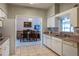 Classic kitchen with white cabinets and a view to the adjacent dining area at 1983 Stacey Cir, Deltona, FL 32738
