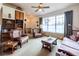 Cozy living room features vintage furniture, a large window, and carpeted floors creating a comfortable space at 1983 Stacey Cir, Deltona, FL 32738