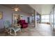 Spacious sunroom offering tile floors, ceiling fans, and tranquil waterfront scenery at 1983 Stacey Cir, Deltona, FL 32738