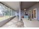 Extended sunroom with tiled floors, ceiling fan, and views of the tranquil lake at 1983 Stacey Cir, Deltona, FL 32738
