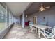 Large sunroom with tiled floors, ceiling fans, and sliding doors leading to serene lake views at 1983 Stacey Cir, Deltona, FL 32738