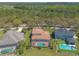 Expansive aerial view of a home with a screened pool and well-manicured lawn at 20 Promenade At Lionspaw, Daytona Beach, FL 32124