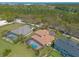 Aerial shot of a home with a screened-in pool and lush landscaping, backing onto a wooded area at 20 Promenade At Lionspaw, Daytona Beach, FL 32124