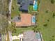 Overhead view of a house with a screened-in pool, complemented by lush landscaping and a paved driveway at 20 Promenade At Lionspaw, Daytona Beach, FL 32124